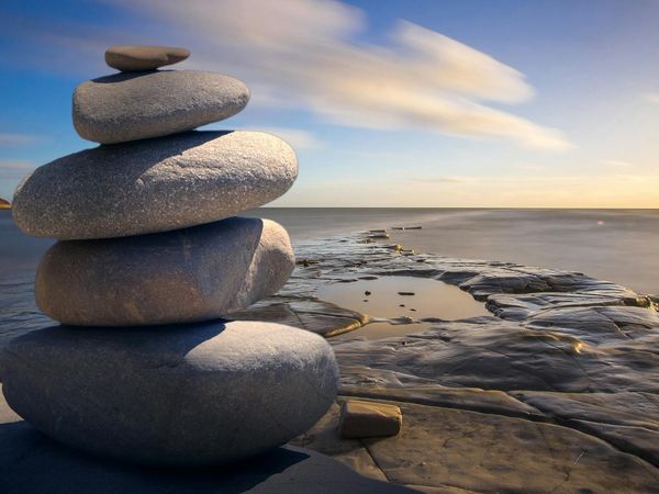 Balanced stones on a serene natural background, symbolizing harmony and stability.